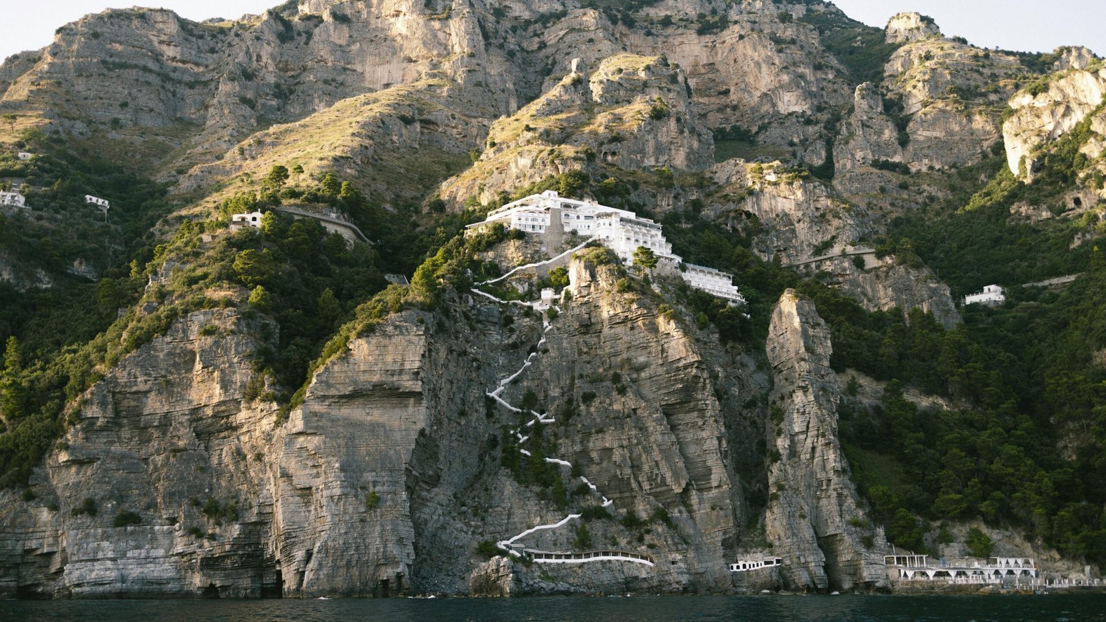 Breathtaking view of the rocky cliffs and Mediterranean sea along Positano's stunning Amalfi Coast.