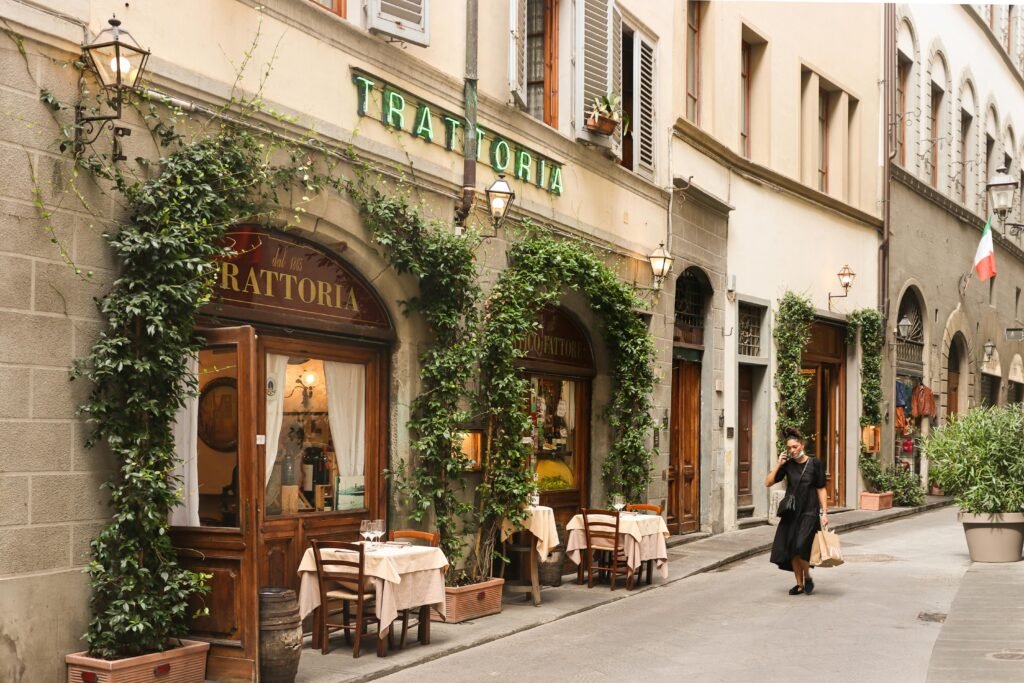 Traditional Italian trattoria facade with climbing plants in Florence, Italy, capturing urban charm.